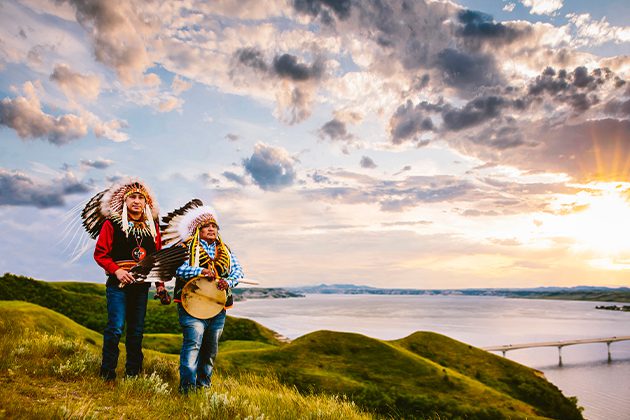 A couple of people that are standing in the grass