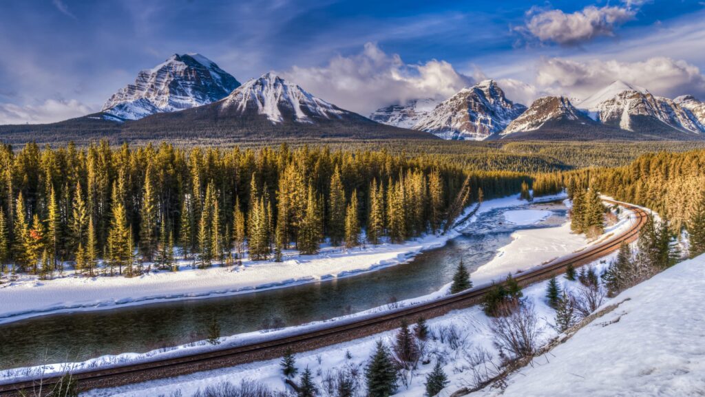 A railroad through a snow covered forest in Canada