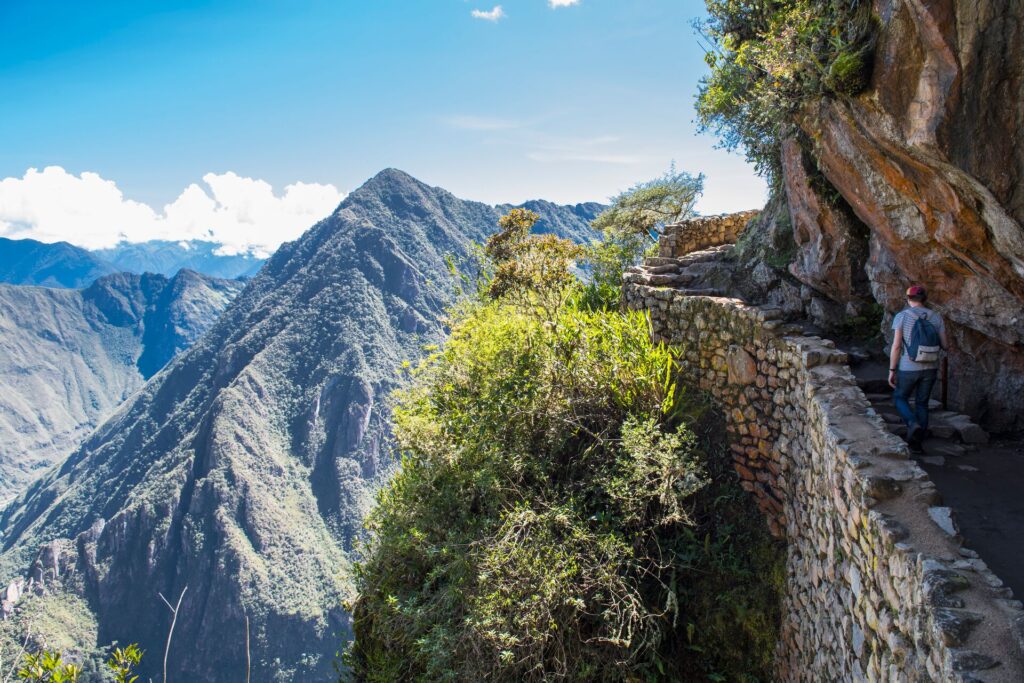Person climbing up path in mountains