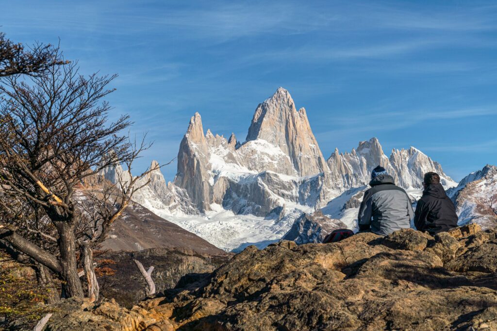 two people in sitting down overlooking a mountain