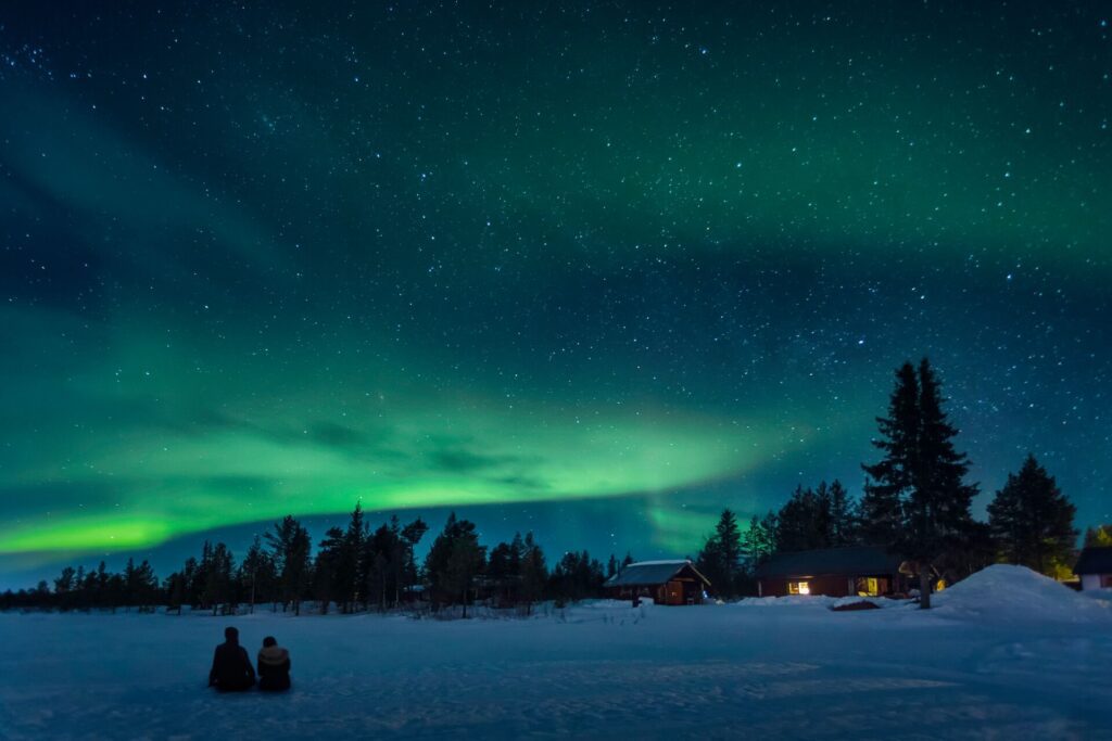 two people watching the northern lights