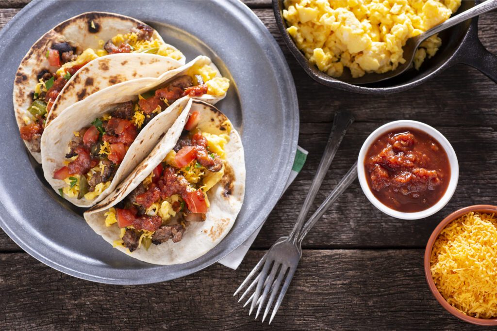 Breakfast Tacos with Eggs, Sausage, Sautéed Pepper and Onion, Tomato, Salsa and Shredded Cheese