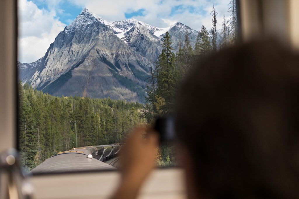Guest taking photo of mountains in GoldLeaf dome.