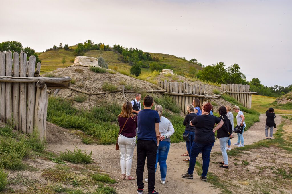International group tour visiting On A Slant Indian Village at Fort Abraham Lincoln State Park