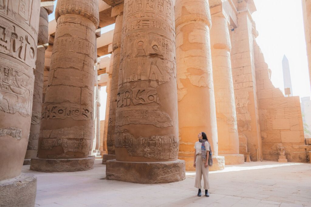 Woman walking through Luxor Temple