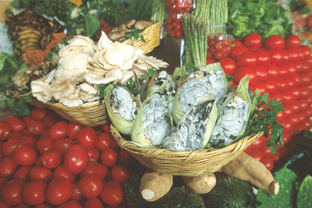 A display of fresh vegetables in baskets on a table