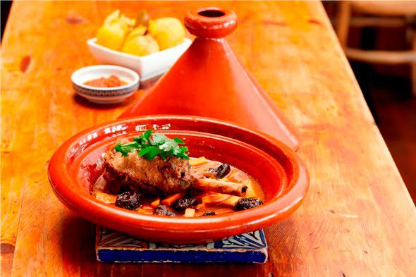 Lamb shank tagine with prunes and carrots served with couscous