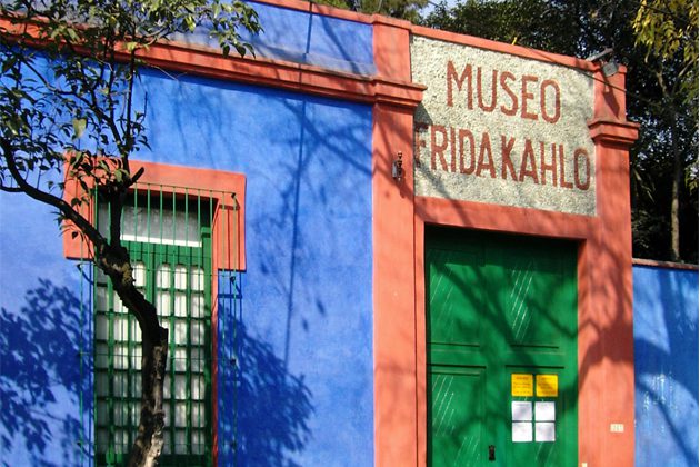 A blue and red building with a green door