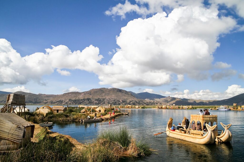 People in boats on floating islands of the Lake Titicaca in Peru
