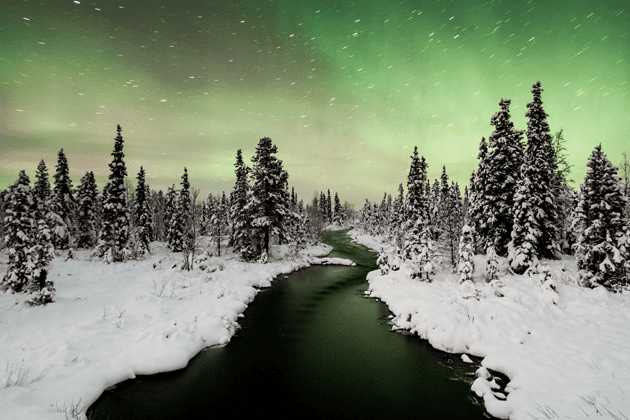 A river running through a snow covered forest