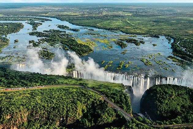 A large waterfall surrounded by lush green trees