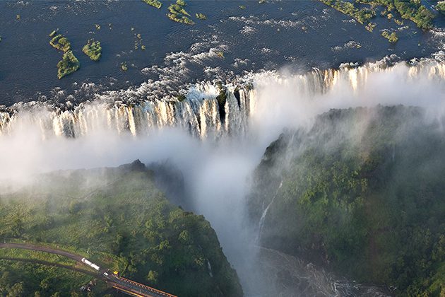 An aerial view of a waterfall and a train