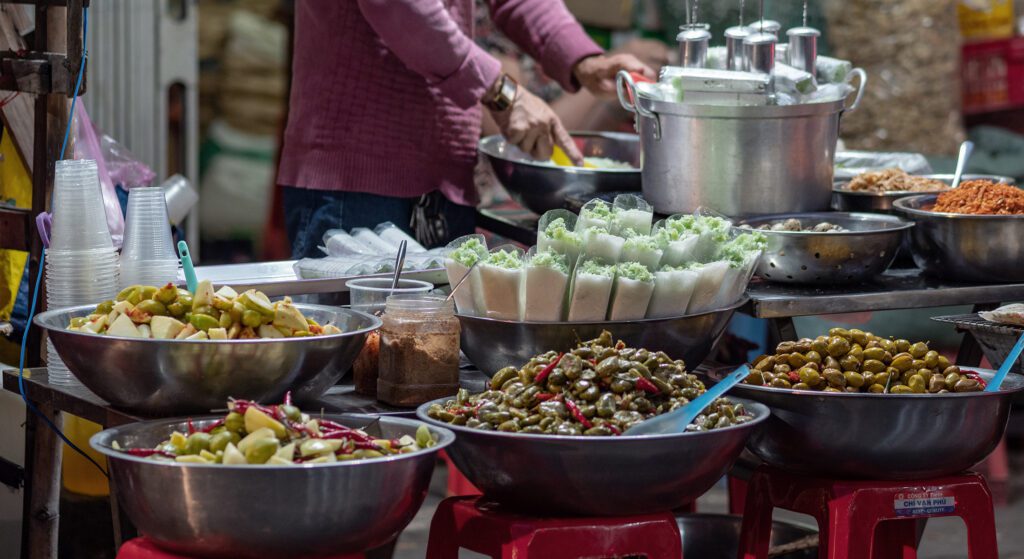 A table filled with bowls of street food in Vietnam