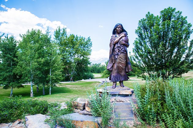 A statue of a woman standing in Sacajawea Interpretative, Cultural & Educational Center