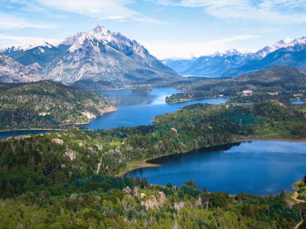 Zoomed out view overlooking multiple lakes under mountains