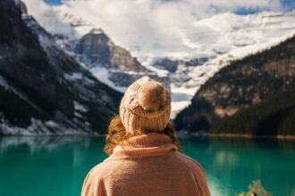 Rear View Of Woman Looking At Lake Against Mountains