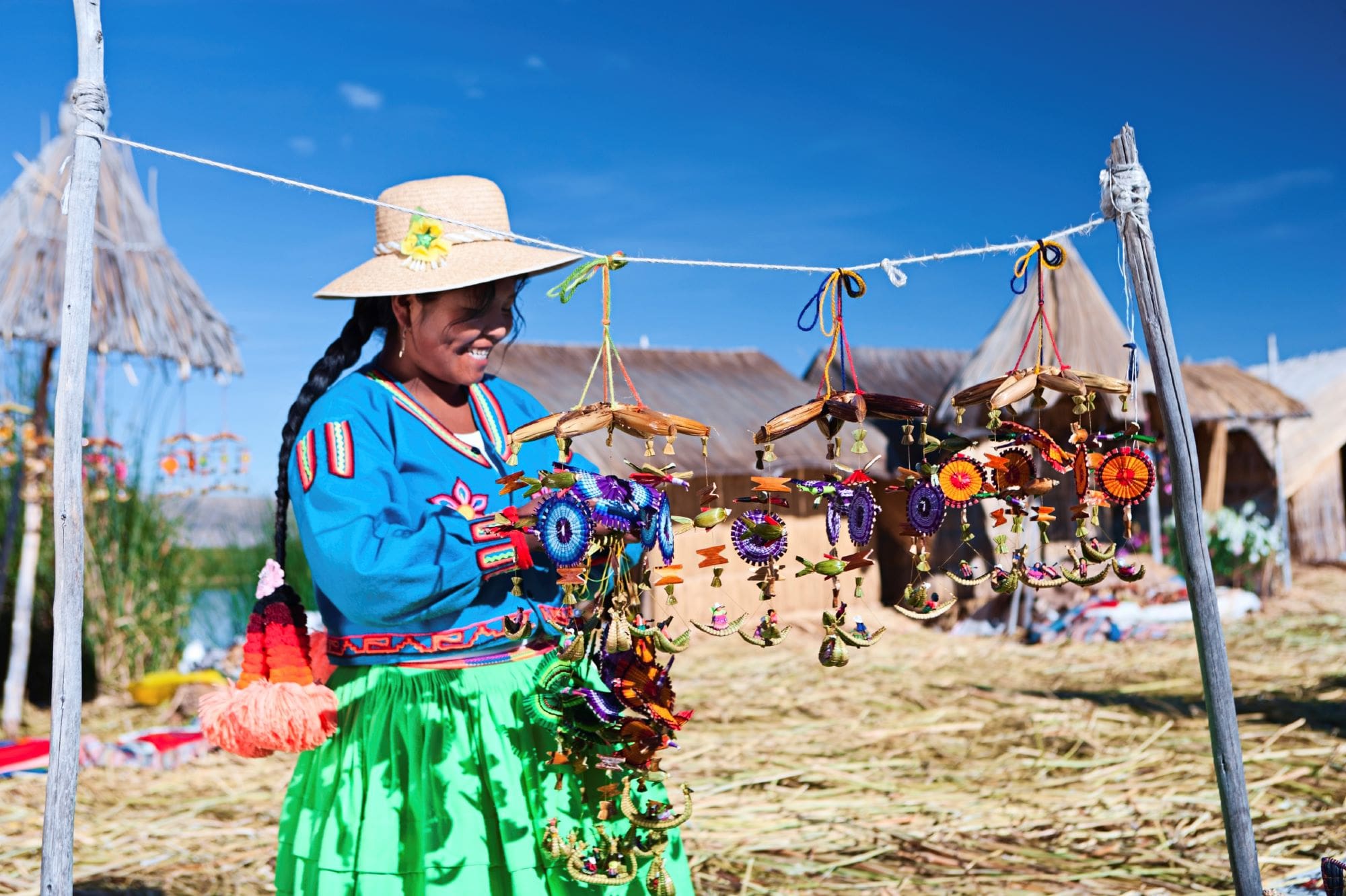 A woman in a straw hat holding a string of beads