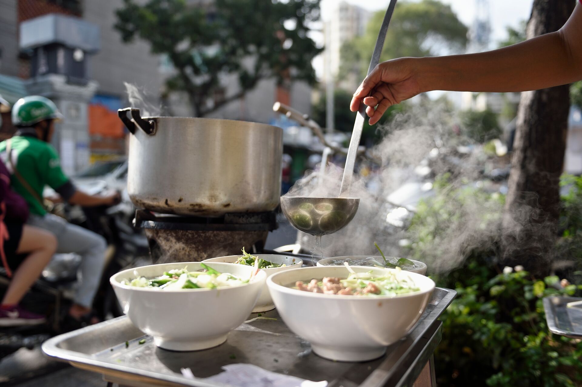 street food stall selling bowls of noodles