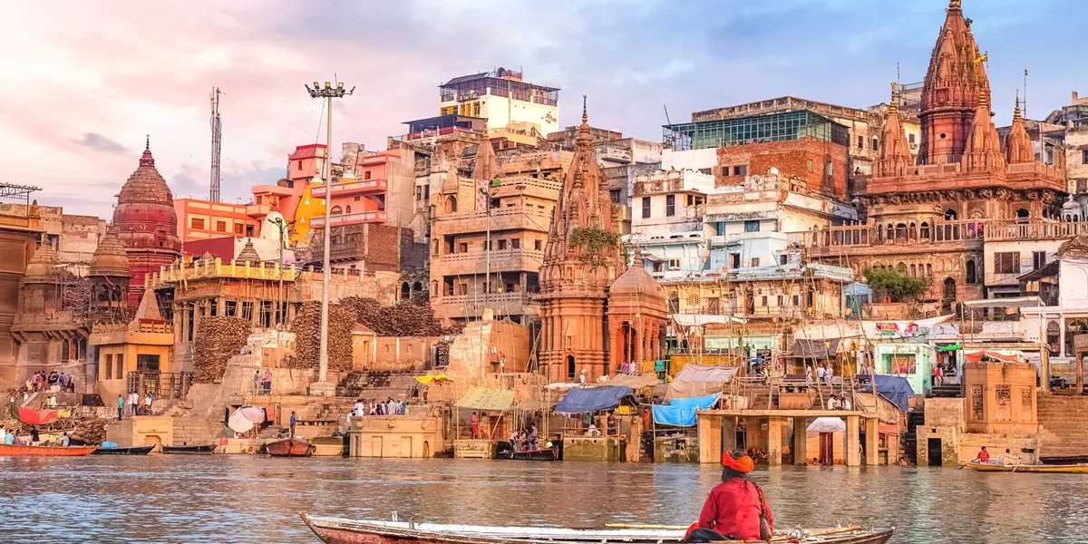 Hindu Sadhu Sitting On A Boat Overlooking The City