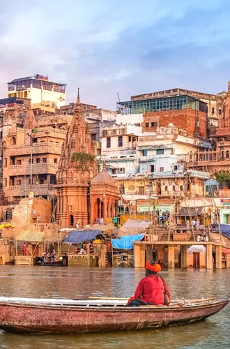 Hindu Sadhu Sitting On A Boat Overlooking The City