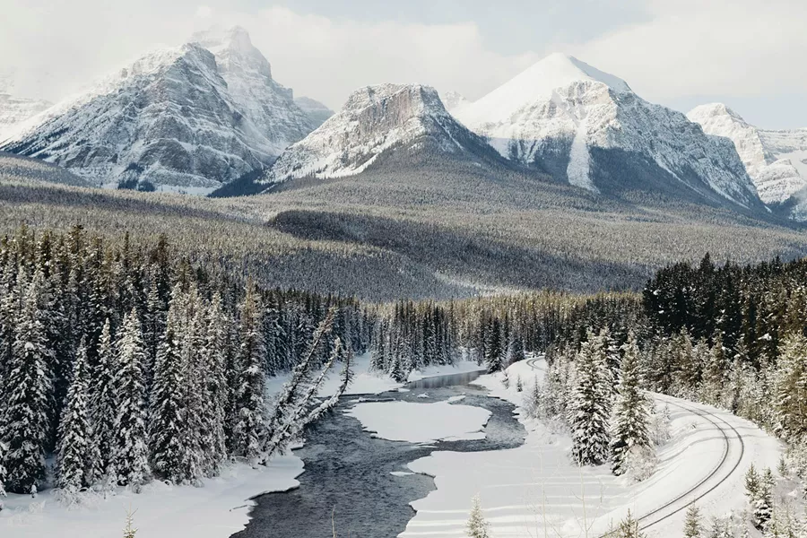 snowy mountain with a rail going in front of it