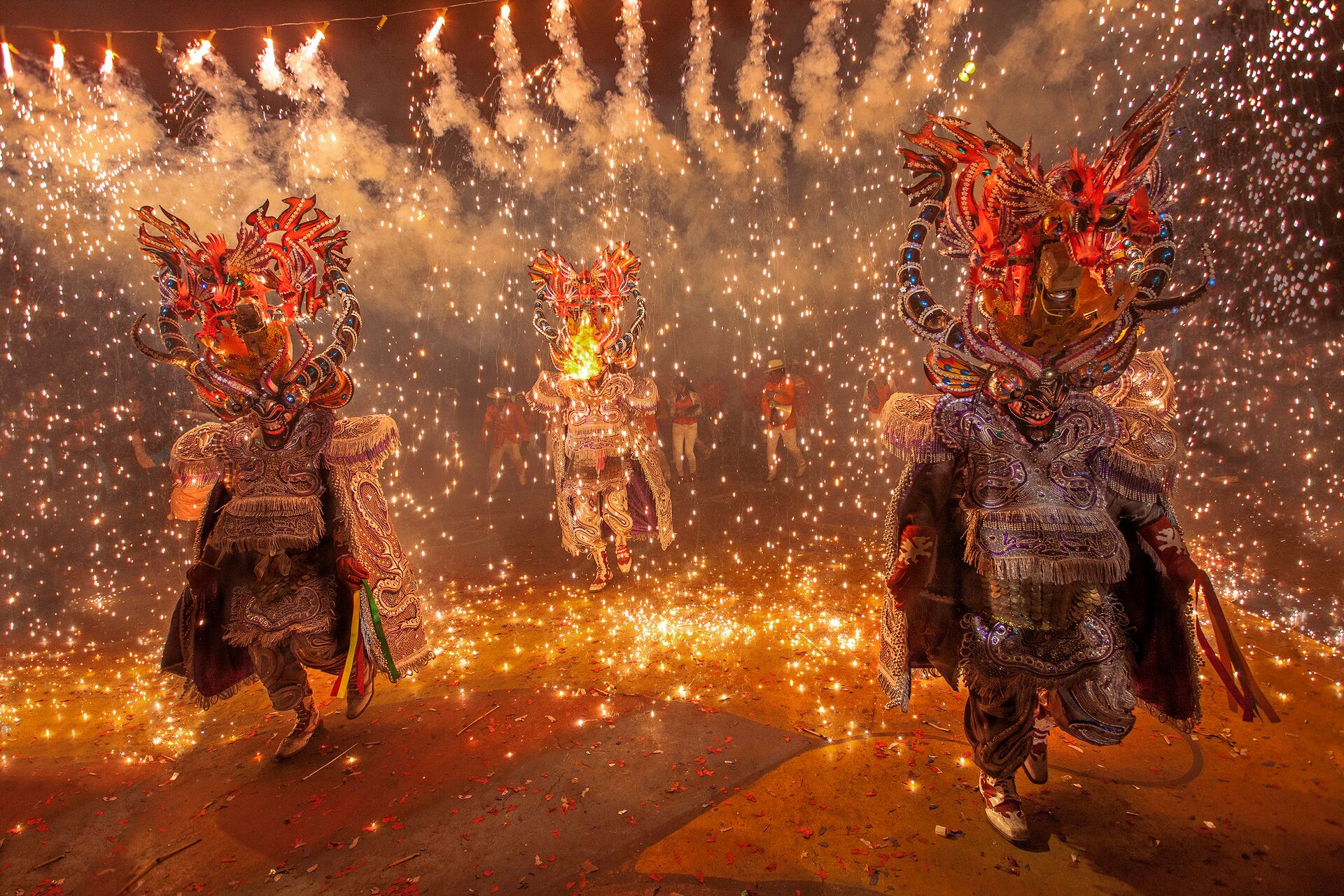 People In Costumes Walking Through Firecrackers at a carnival