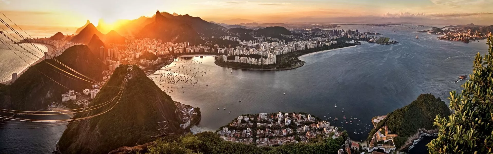 The sun is setting over the city of Rio De Janeiro