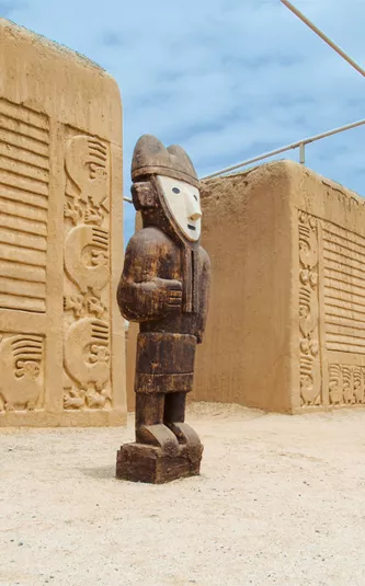 Ancient statues in front of an archaelogical site.