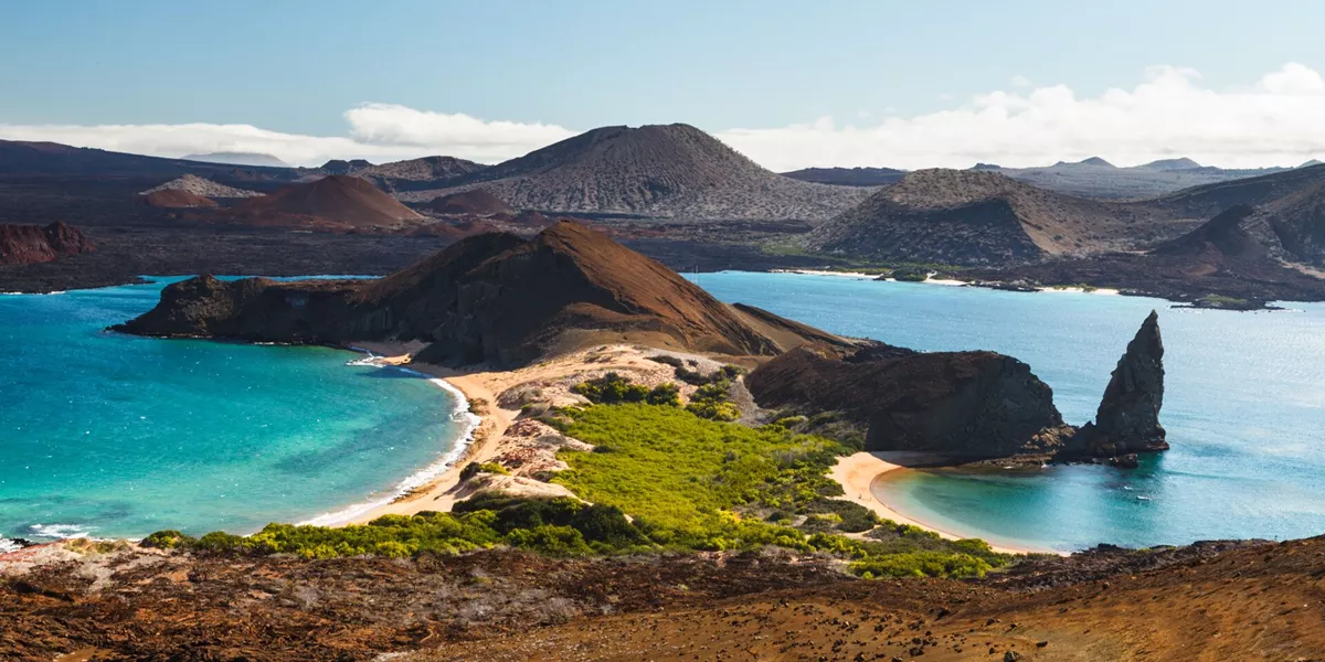View On The Volcanic Landscape Of Bartolome Island With Famous Pinnacle Rock And Golden Beach
