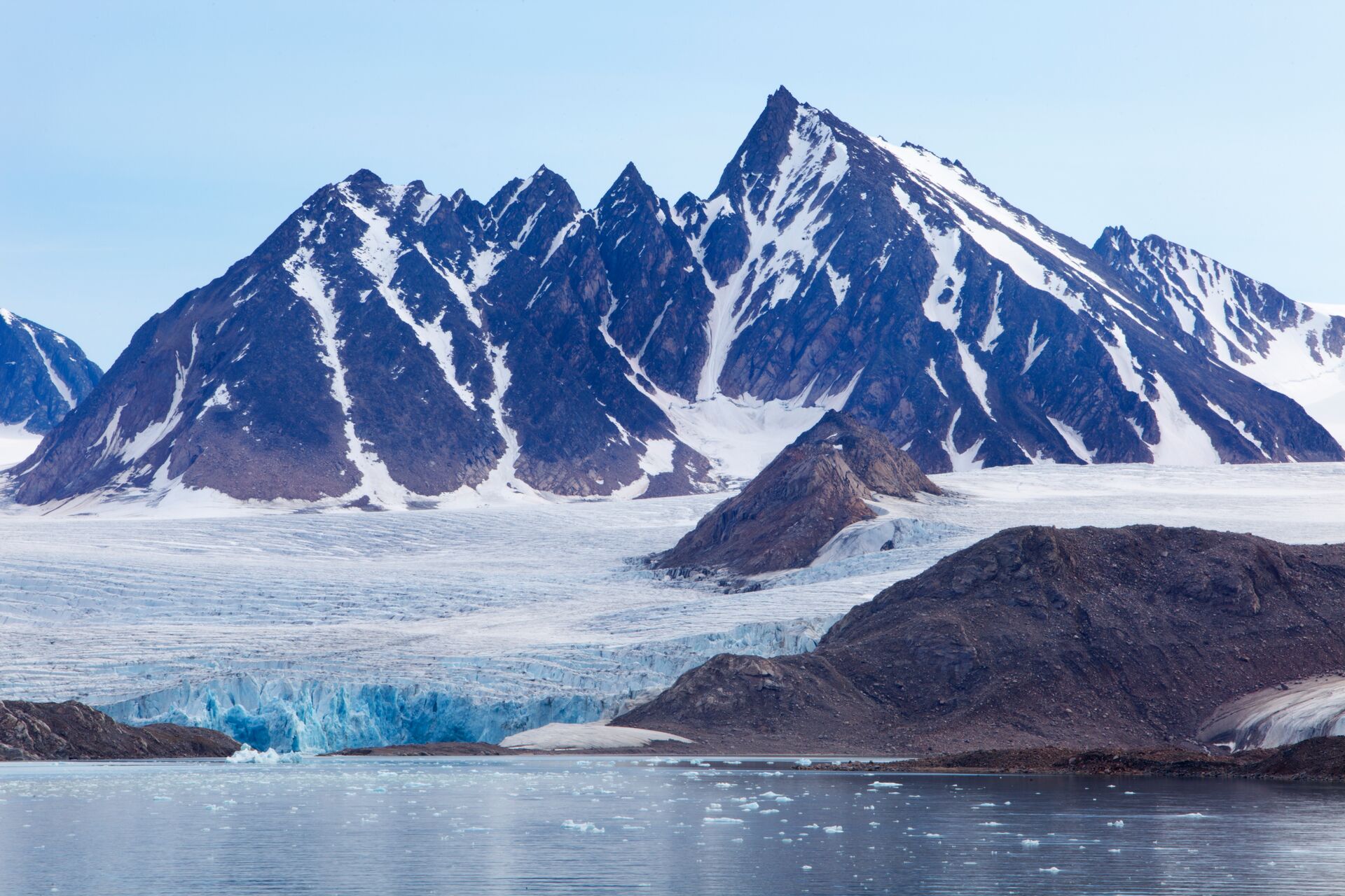 Mountains with a glacier flowing into the ocean