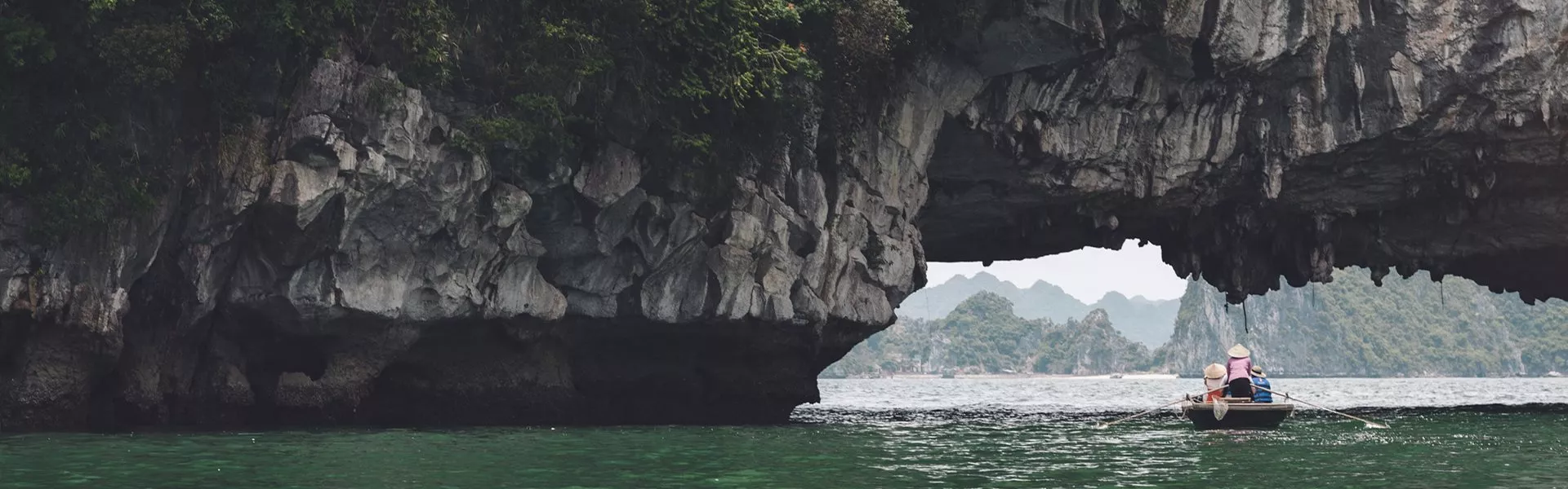 A person in a small boat in Ha Long bay