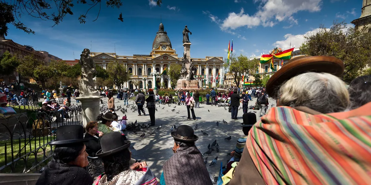People moving around a plaza in traditional clothing