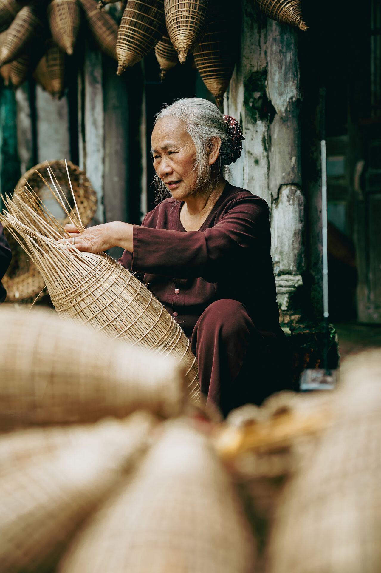 Woman Weaving Baskets In A Handicraft Village