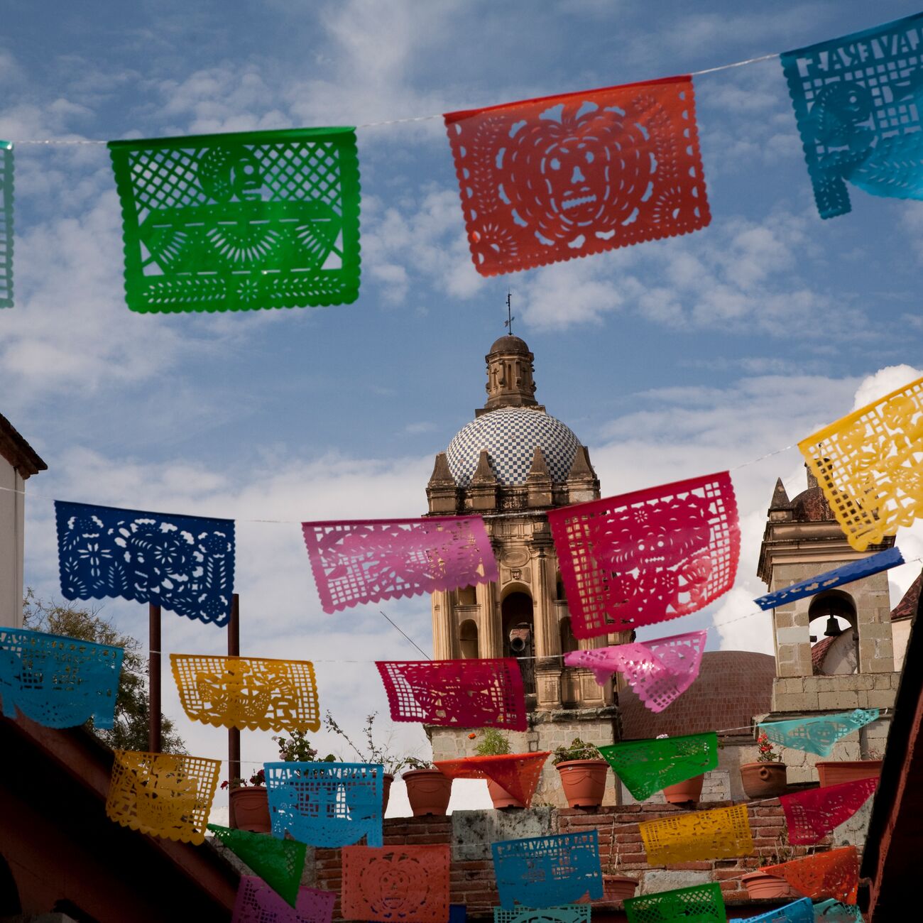 A building with many colorful flags hanging from it's roof