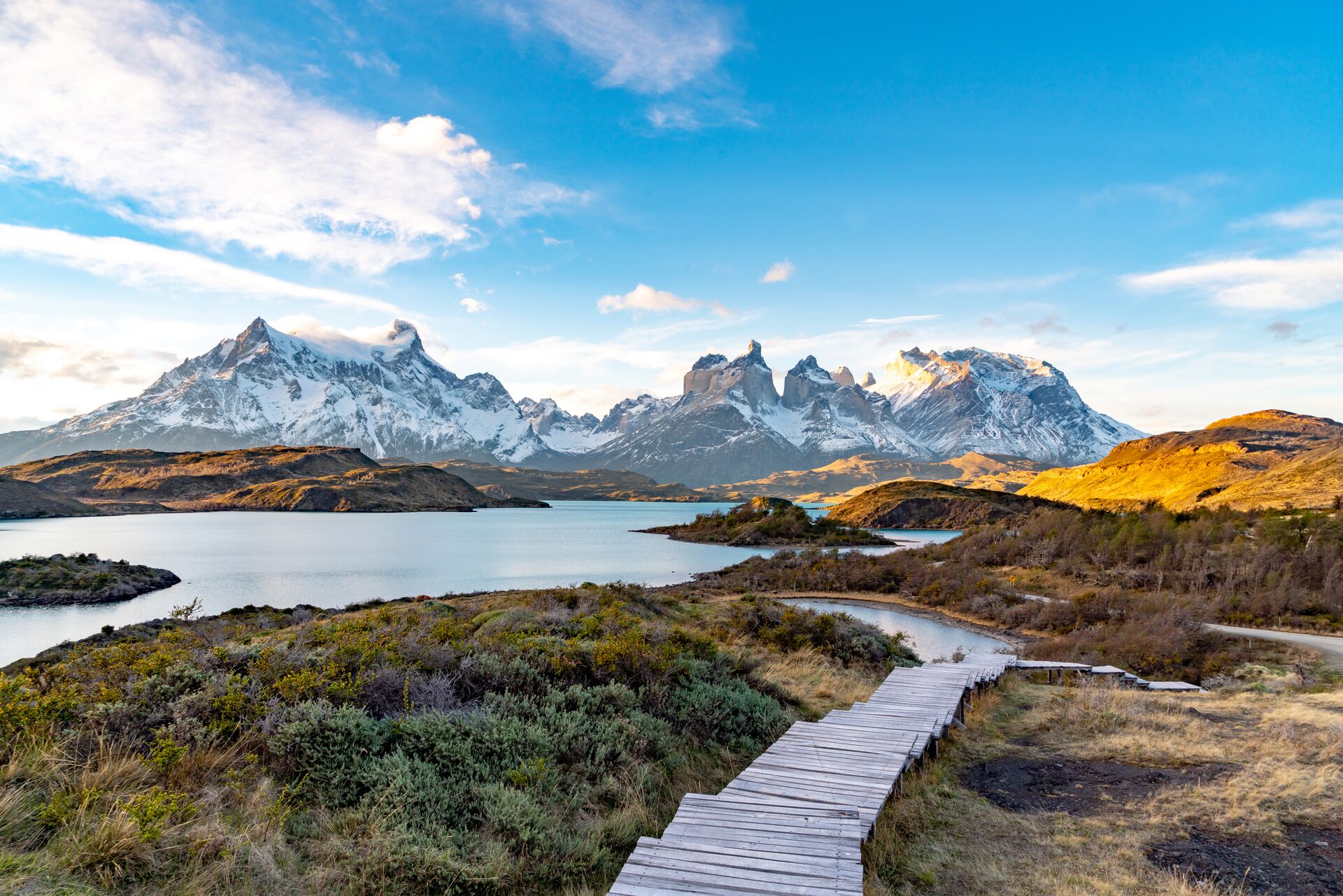 Overlooking a path that leads down to a lake and mountains