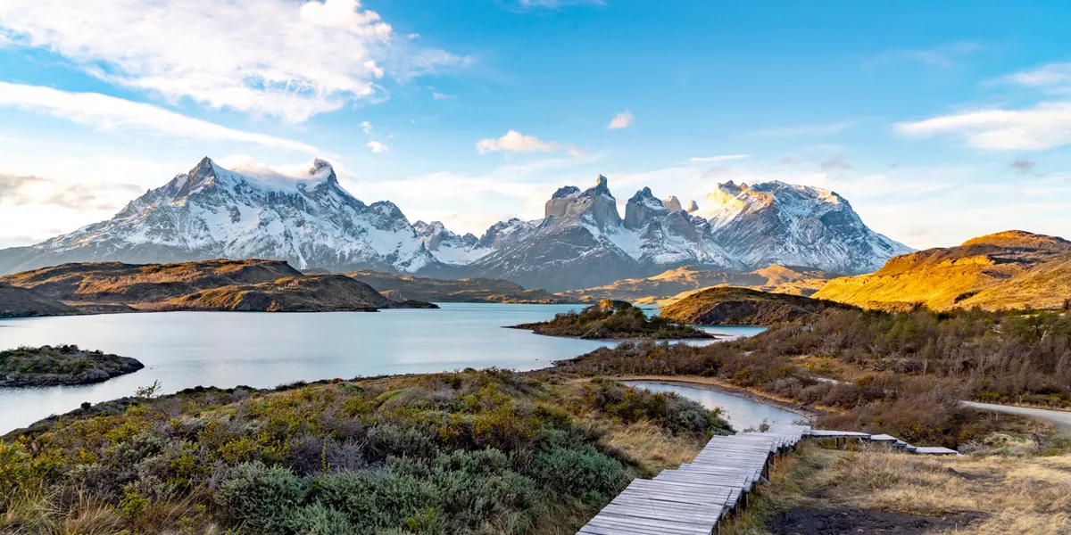 Overlooking a path that leads down to a lake and mountains