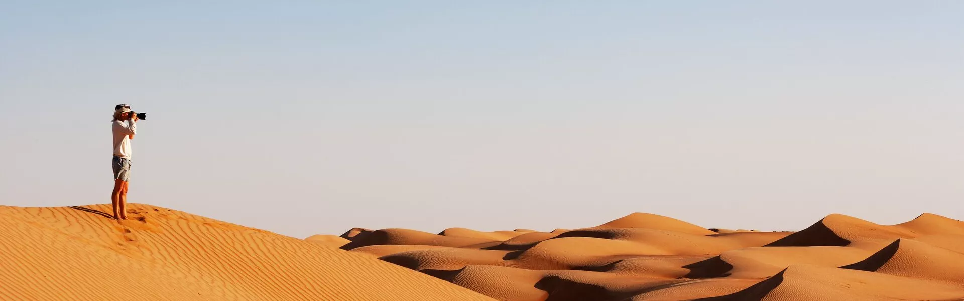 Man Taking Pictures In The Desert