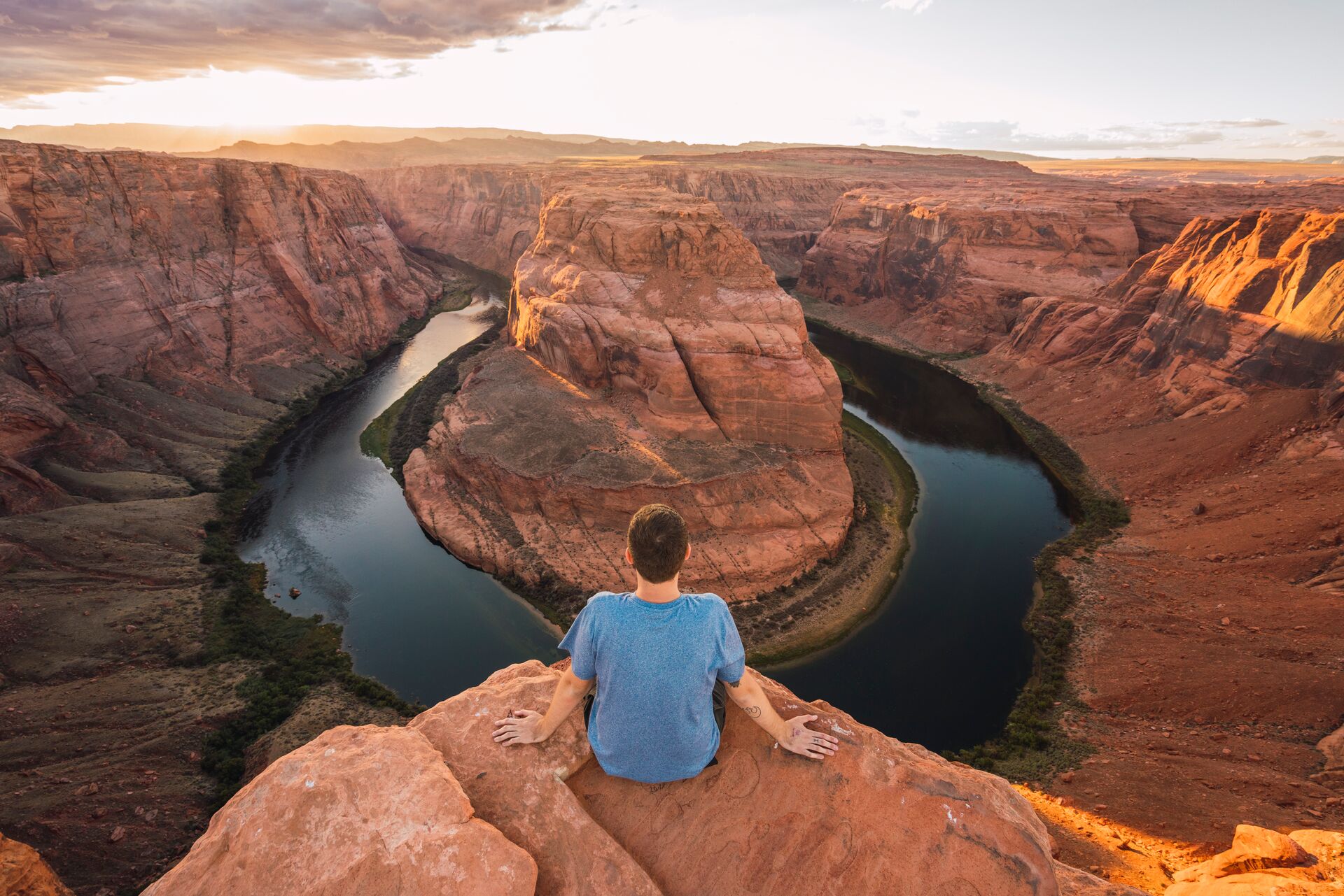 Man sitting on edge of canyon