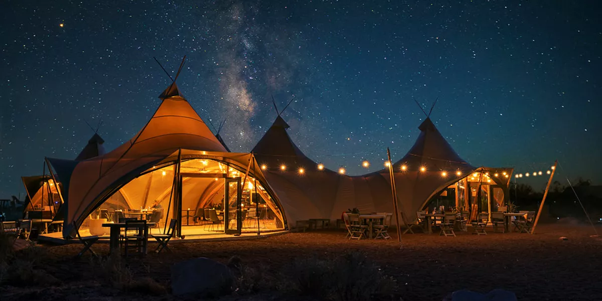 A group of tents sitting under a night sky filled with stars