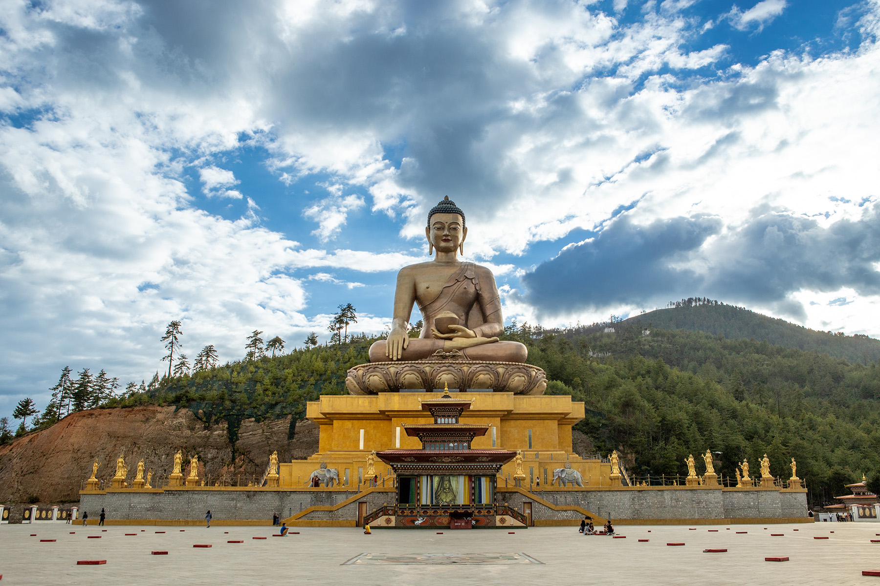 large buddha statue in front of a cloudy sky