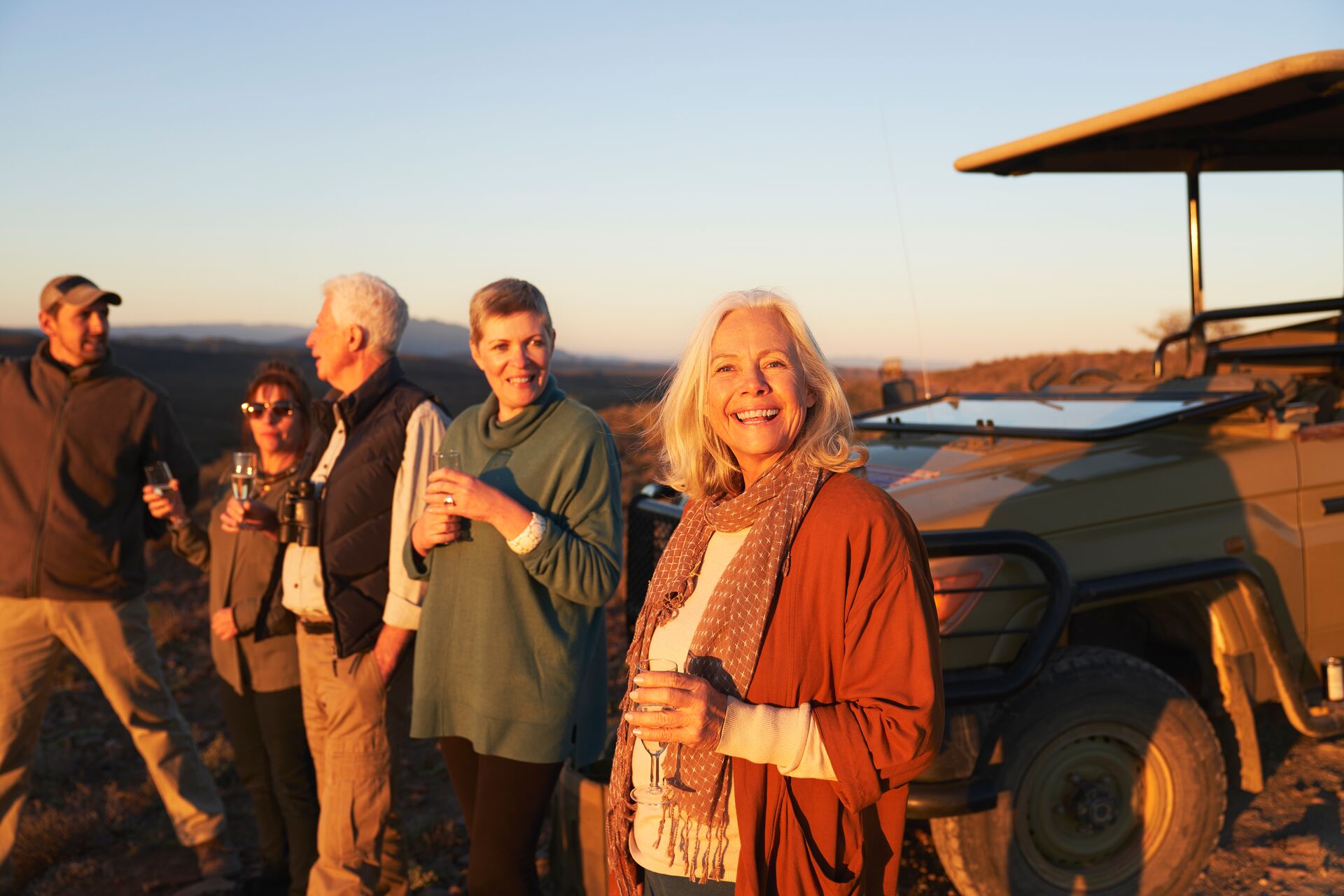Africa Portrait Happy Senior Woman On Safari Drinking Champagne With Friends