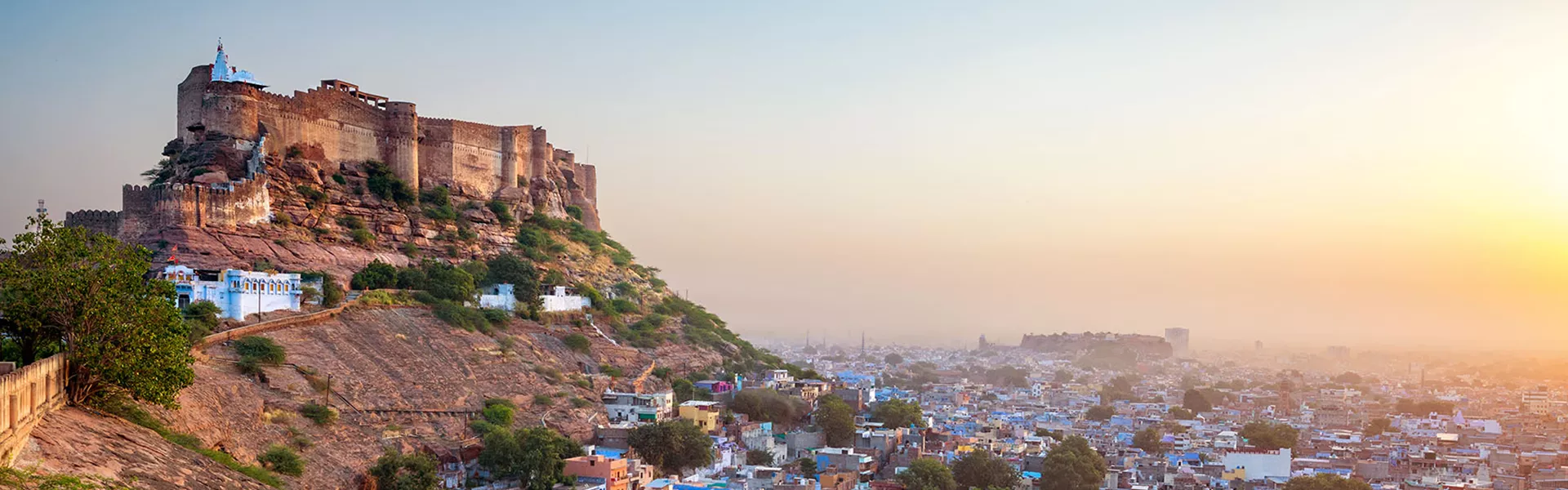 fort overlooking a city full of blue buildings