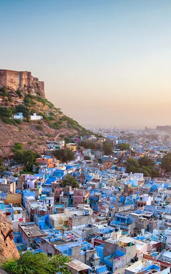 fort overlooking a city full of blue buildings