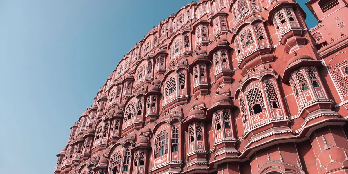 A large pink building with many windows and balconies