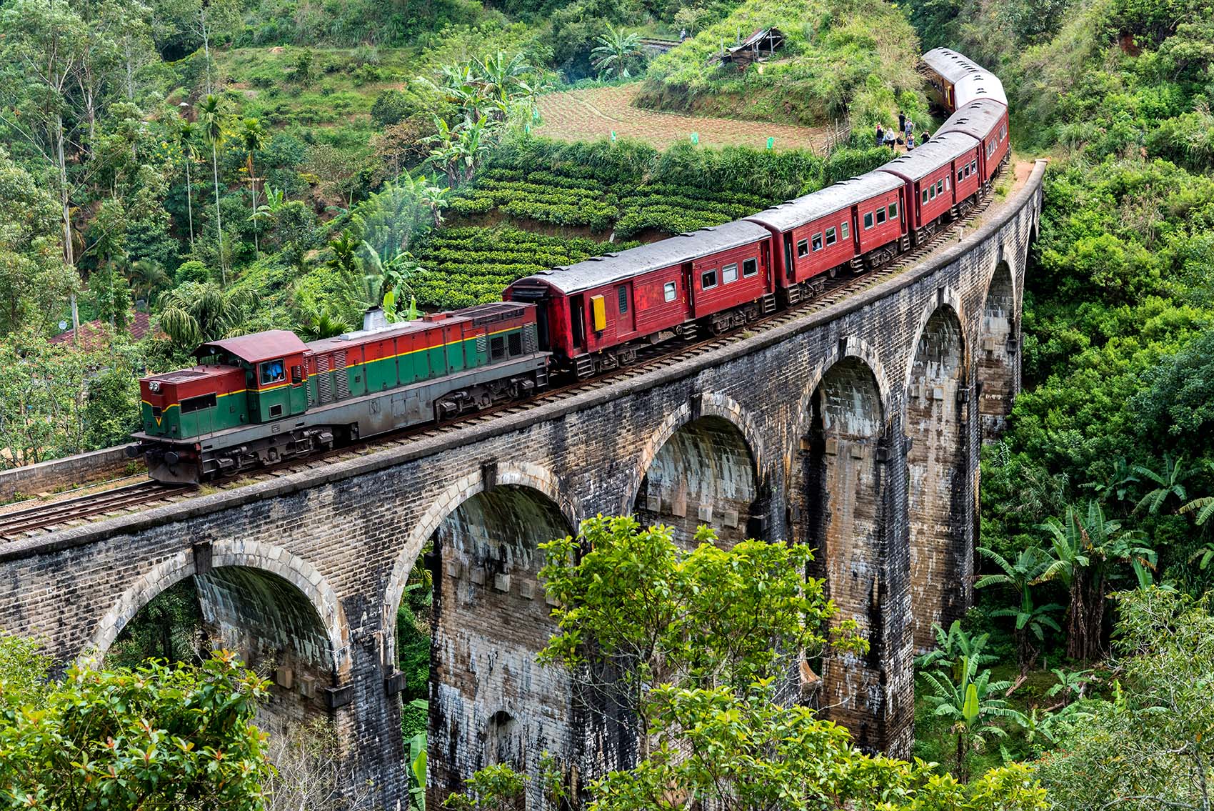 Train going over a stone bridge