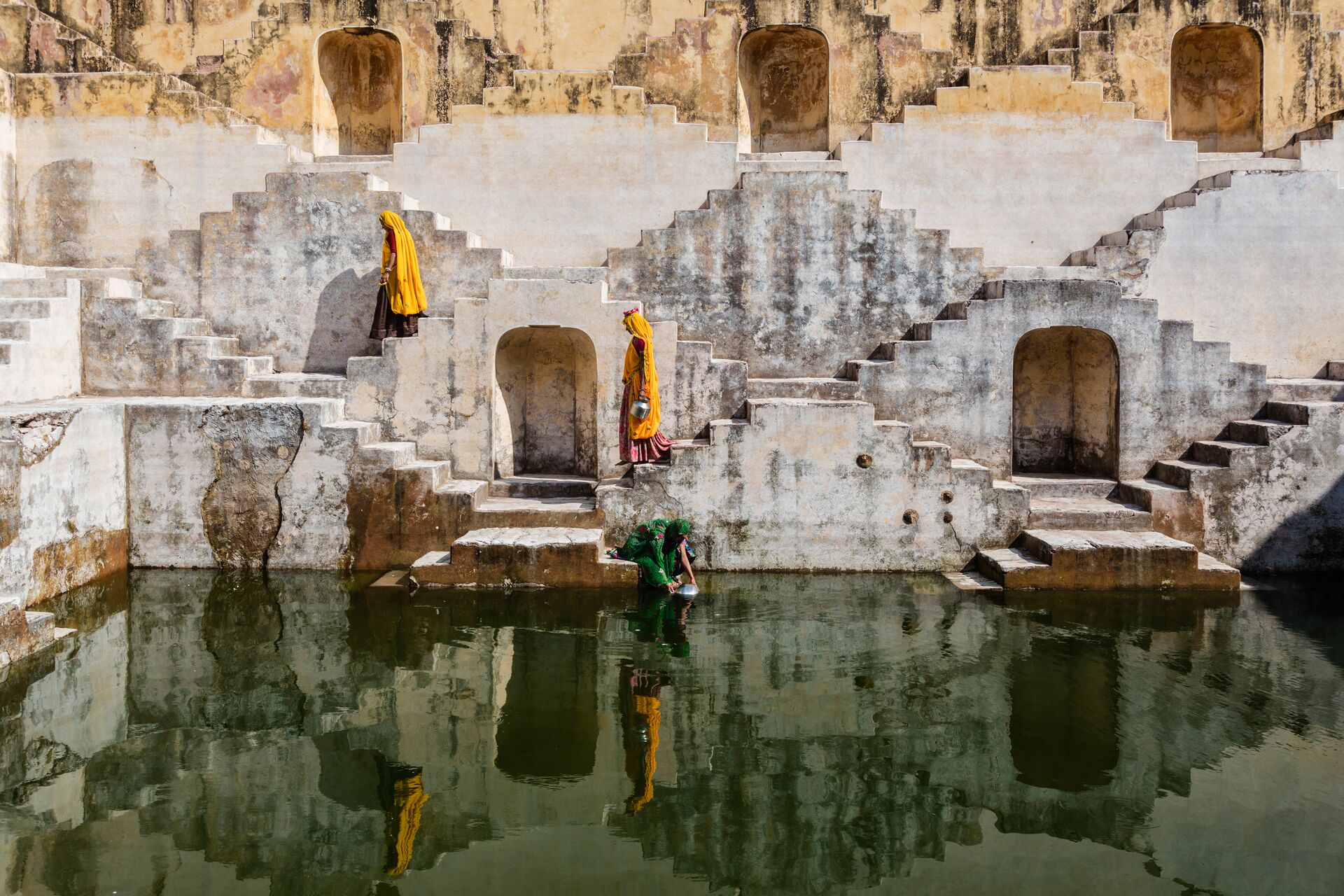Women In Saris Carrying Water At Step Well