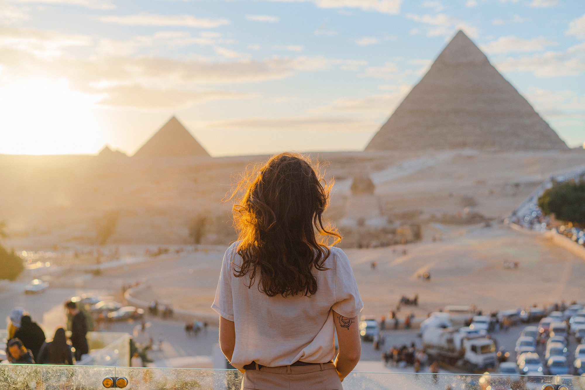 Woman Standing On The Terrace On The Background Of Giza Pyramids
