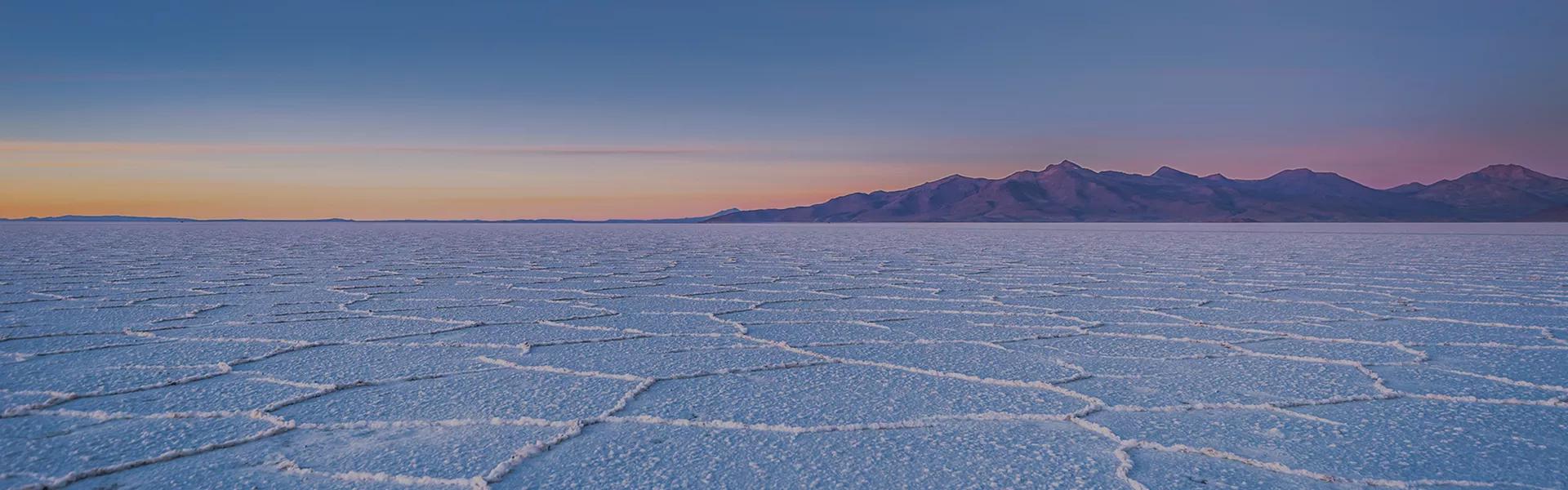 Vast salt flats with mountains in the distance