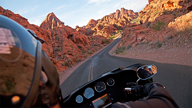 A person riding a motorcycle down a curvy road