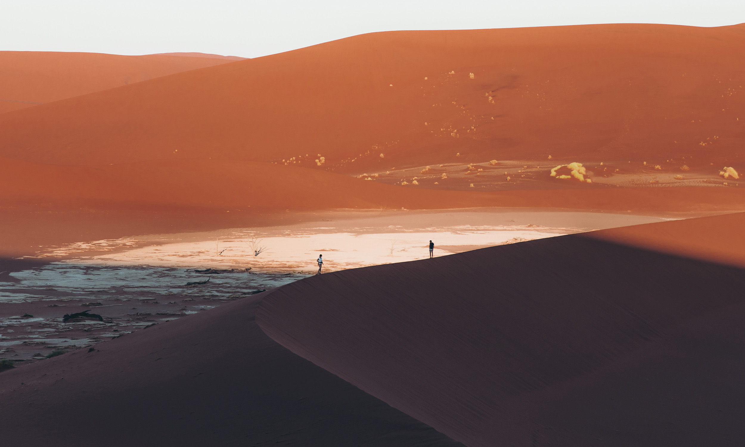 two travellers on large sand dunes